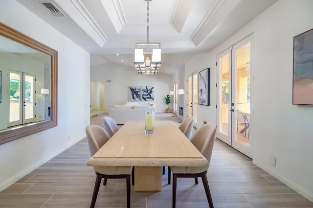 a view of a dining room with furniture and a chandelier
