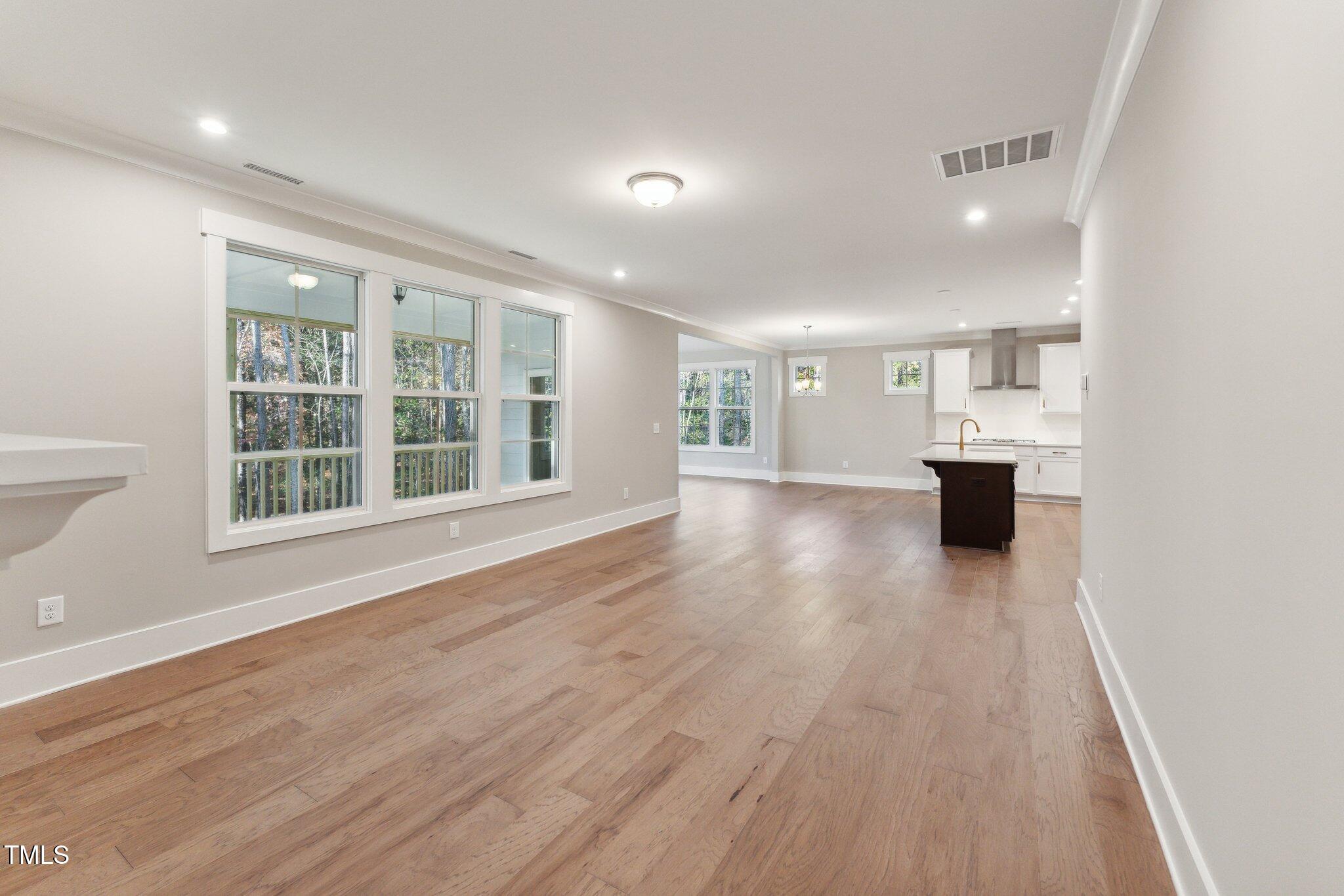 237 Dona Drive Carthage, NC 28327 - Photo 21 of 39 a view of empty room with wooden floor and windows