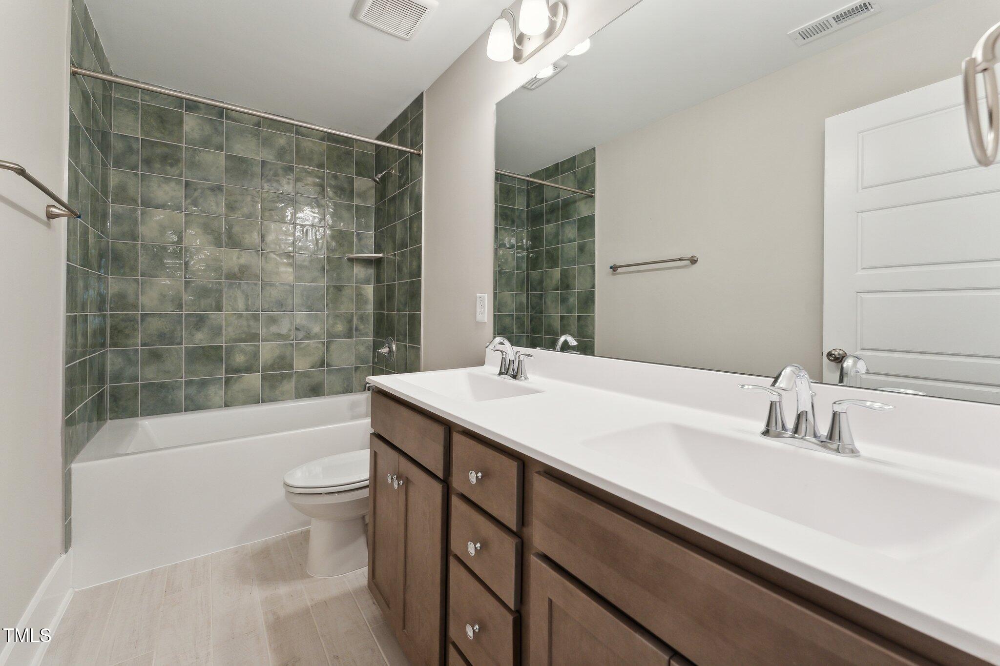 237 Dona Drive Carthage, NC 28327 - Photo 25 of 39 a bathroom with a sink a toilet a mirror and shower