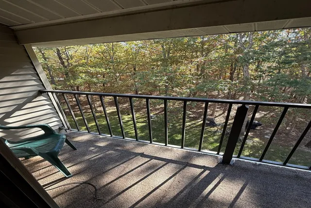 a view of a balcony with wooden floor