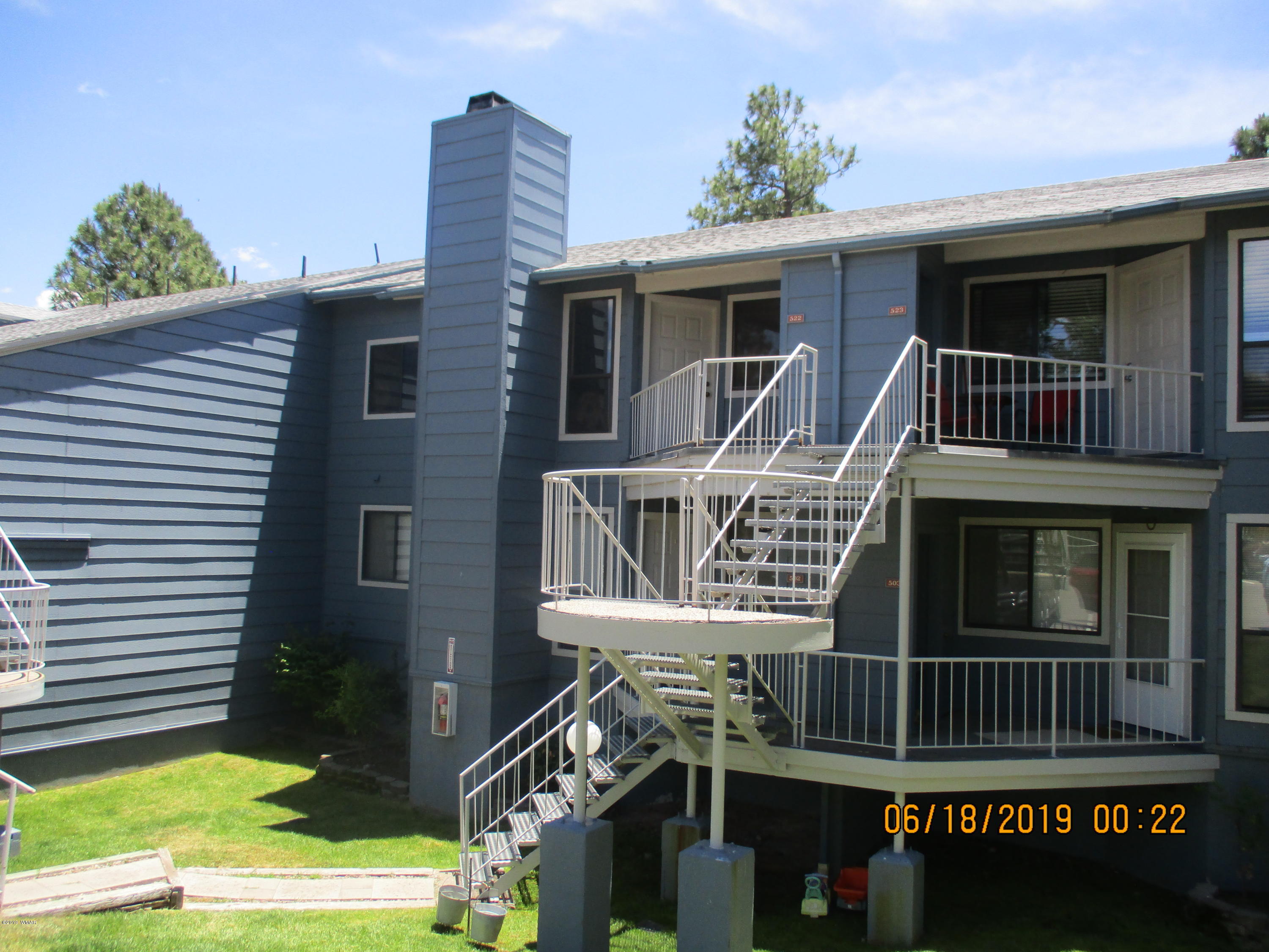 2700 South White Mountain Road, Unit 522 Show Low, AZ 85901 - Photo 1 of 8 a front view of a house with a yard
