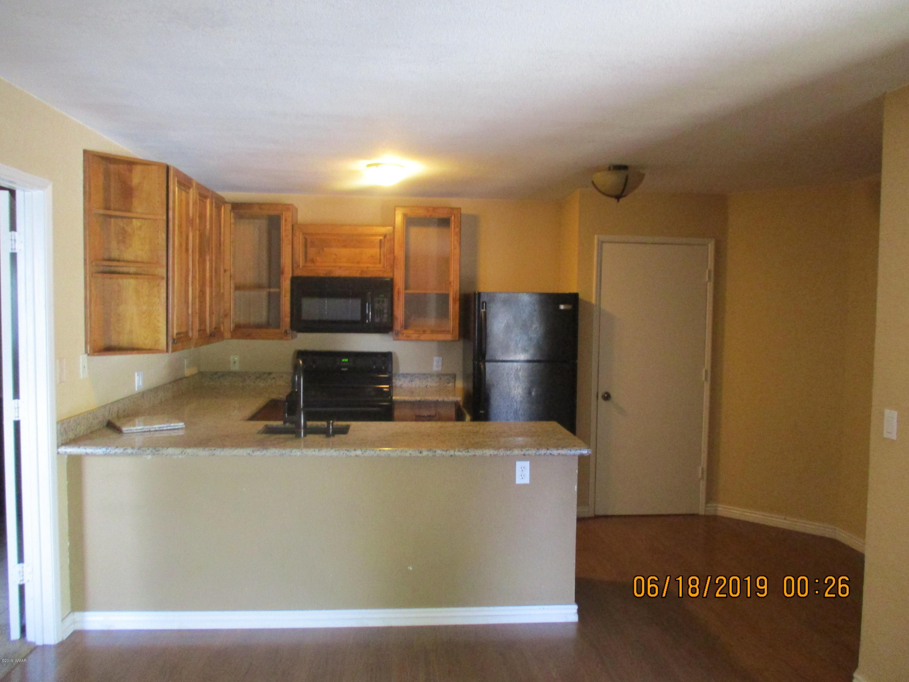 2700 South White Mountain Road, Unit 522 Show Low, AZ 85901 - Photo 3 of 8 a view of a refrigerator a sink and dishwasher