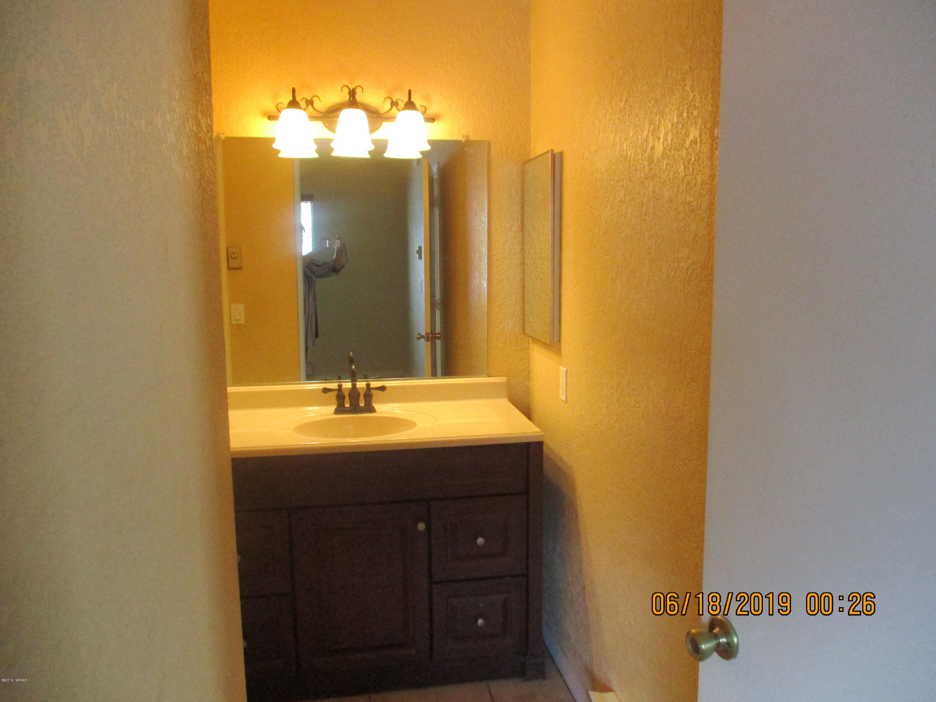 2700 South White Mountain Road, Unit 522 Show Low, AZ 85901 - Photo 5 of 8 a bathroom with a sink and a mirror