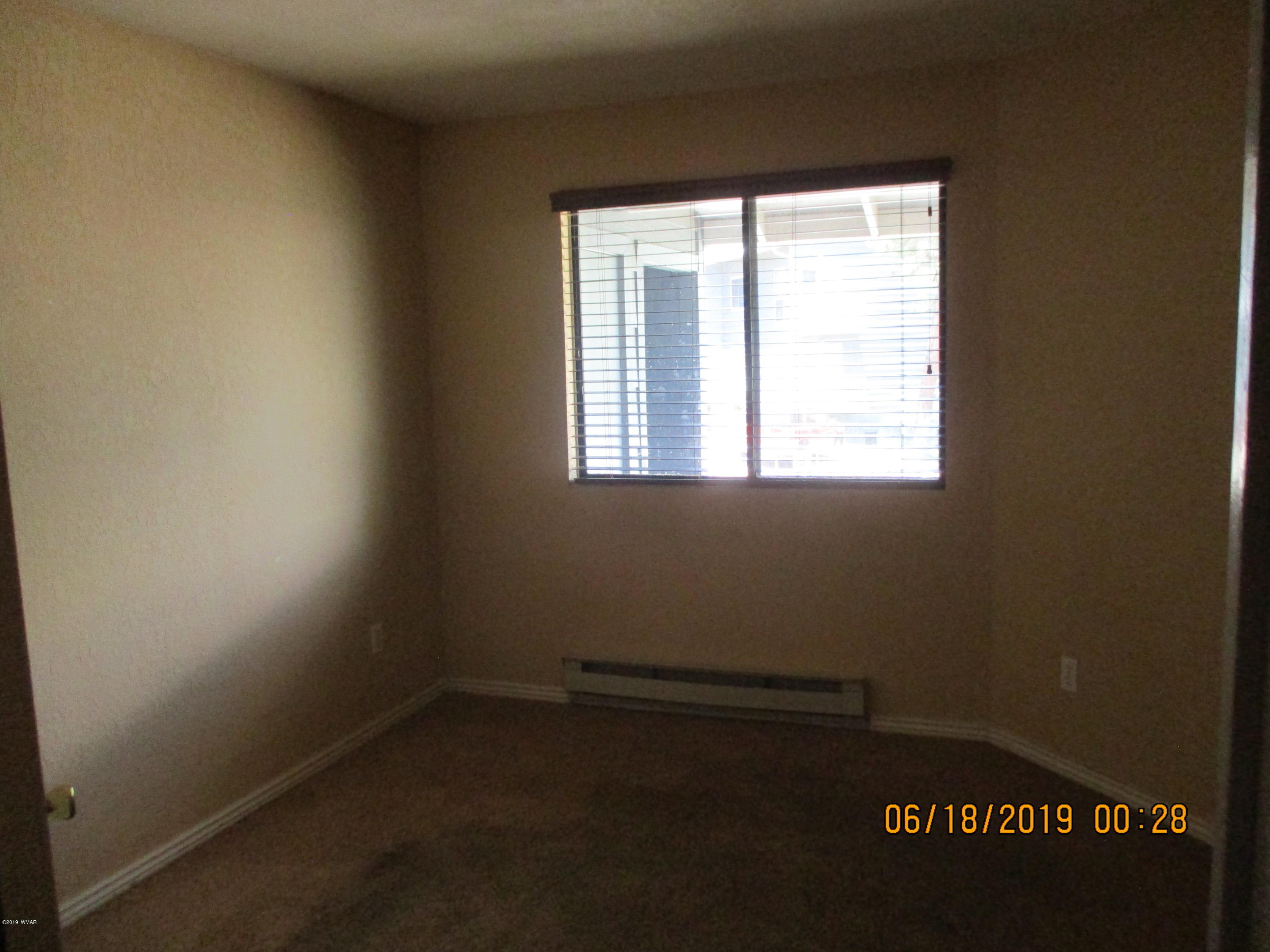 2700 South White Mountain Road, Unit 522 Show Low, AZ 85901 - Photo 7 of 8 an empty room with a window