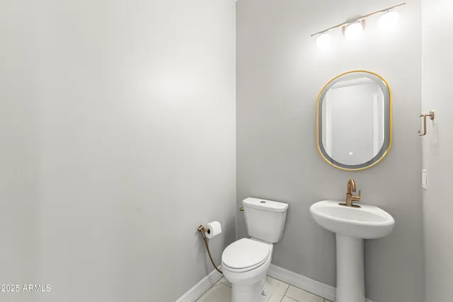 a bathroom with a sink a mirror and a toilet