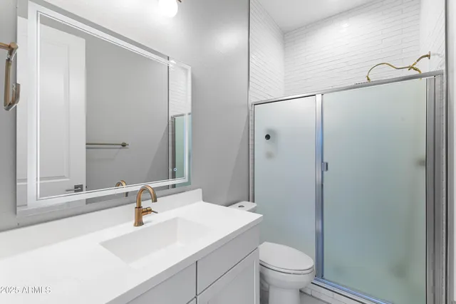 a bathroom with a sink toilet and shower