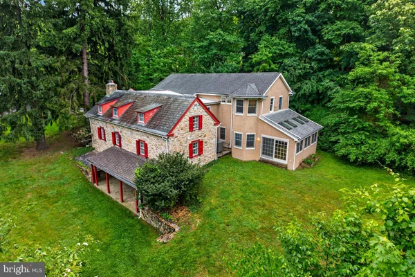 an aerial view of a house with a big yard
