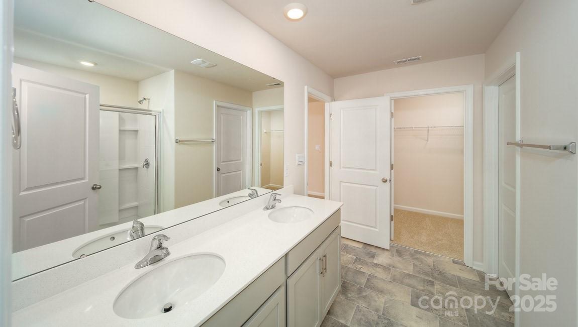 180 Salers Road Fletcher, NC 28732 - Photo 15 of 29 a bathroom with a double vanity sink mirror and double