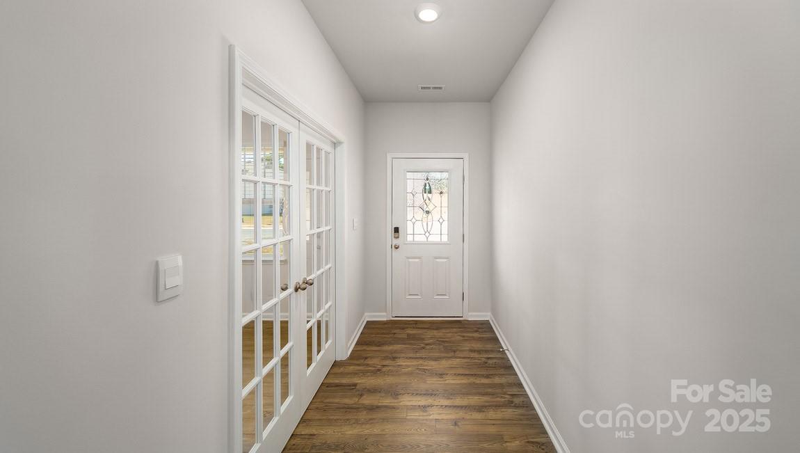 180 Salers Road Fletcher, NC 28732 - Photo 9 of 29 a view of a hallway with wooden floor and a bathroom