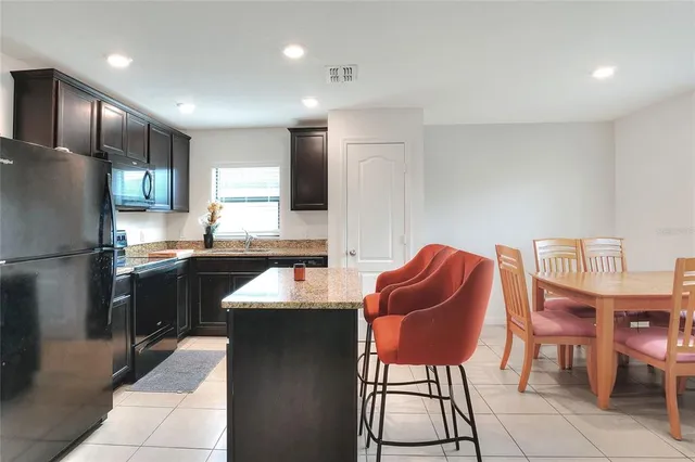 a kitchen with a sink refrigerator and cabinets