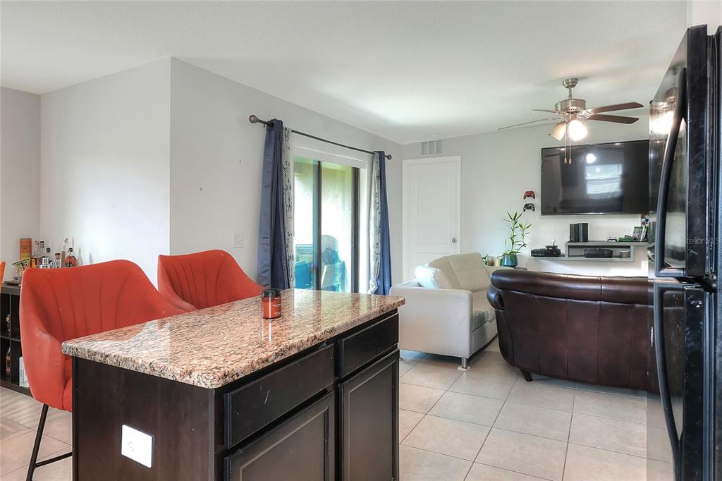 2166 Mandarin Loop Dundee, FL 33838 - Photo 14 of 44 a living room with furniture and a flat screen tv