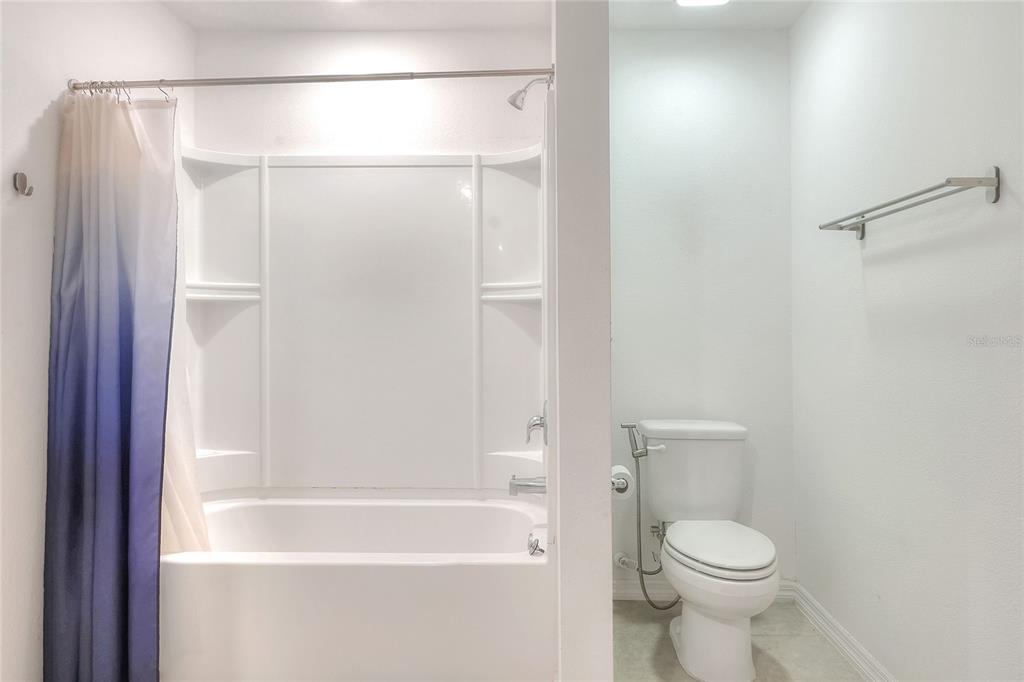 2166 Mandarin Loop Dundee, FL 33838 - Photo 22 of 44 a bathroom with a shower and a toilet