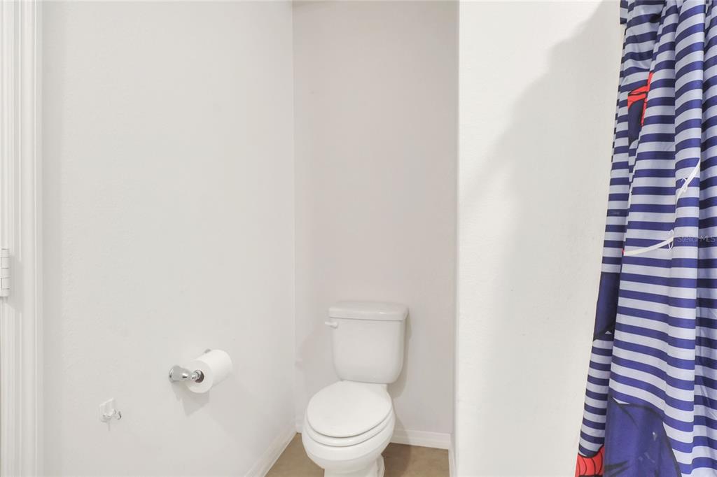 2166 Mandarin Loop Dundee, FL 33838 - Photo 27 of 44 a white toilet sitting next to a shower