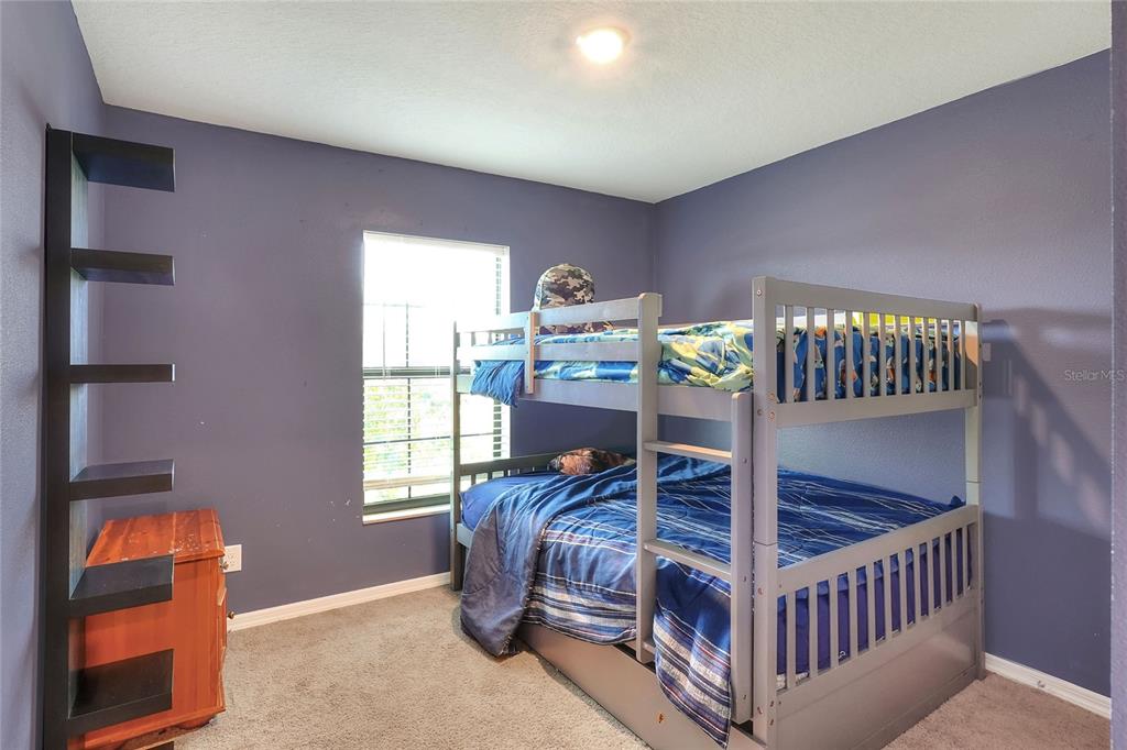 2166 Mandarin Loop Dundee, FL 33838 - Photo 28 of 44 a bedroom with furniture and a window