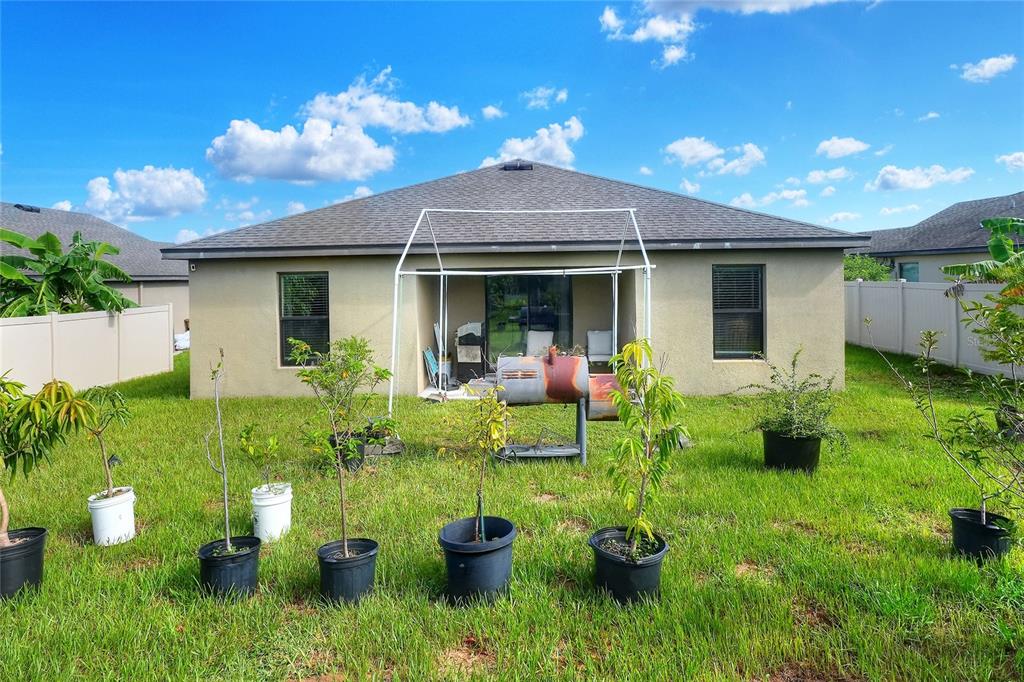 2166 Mandarin Loop Dundee, FL 33838 - Photo 32 of 44 a front view of a house with a yard