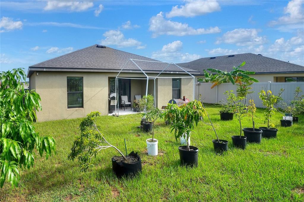 2166 Mandarin Loop Dundee, FL 33838 - Photo 36 of 44 a front view of a house with garden