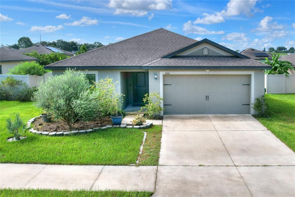 2166 Mandarin Loop Dundee, FL 33838 - Photo 44 of 44 a view of a house with a garden