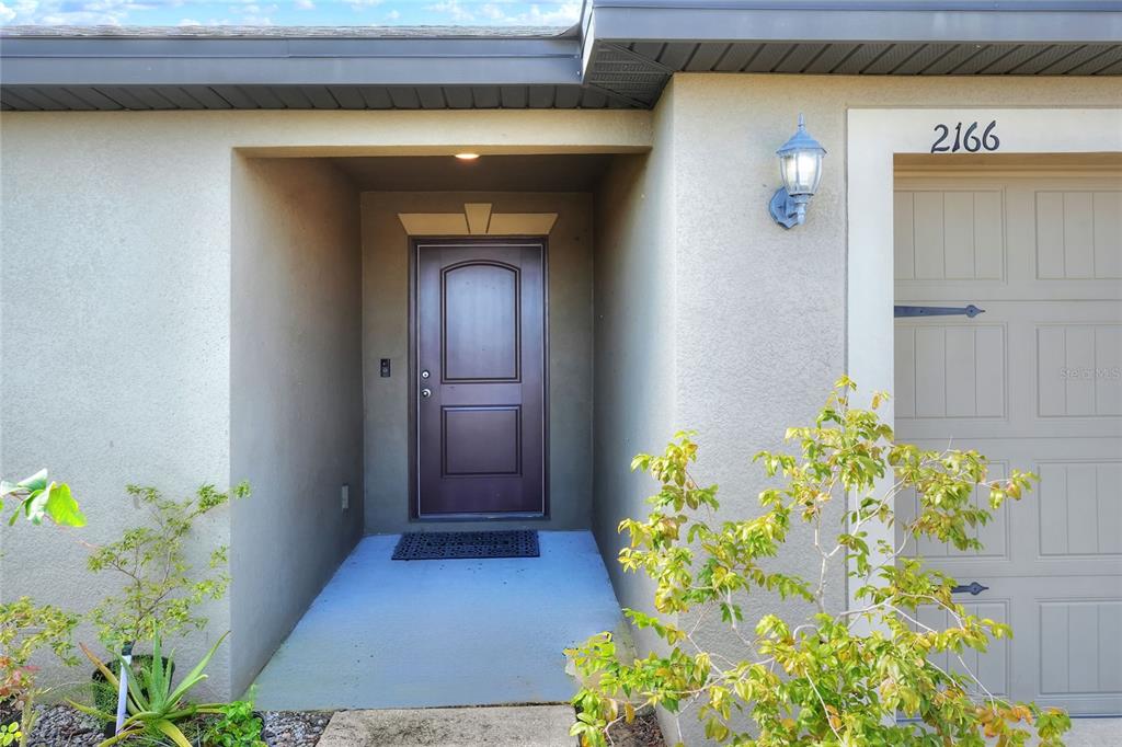 2166 Mandarin Loop Dundee, FL 33838 - Photo 5 of 44 a front view of a house with a yard