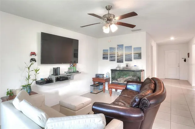 a living room with fireplace furniture and a flat screen tv