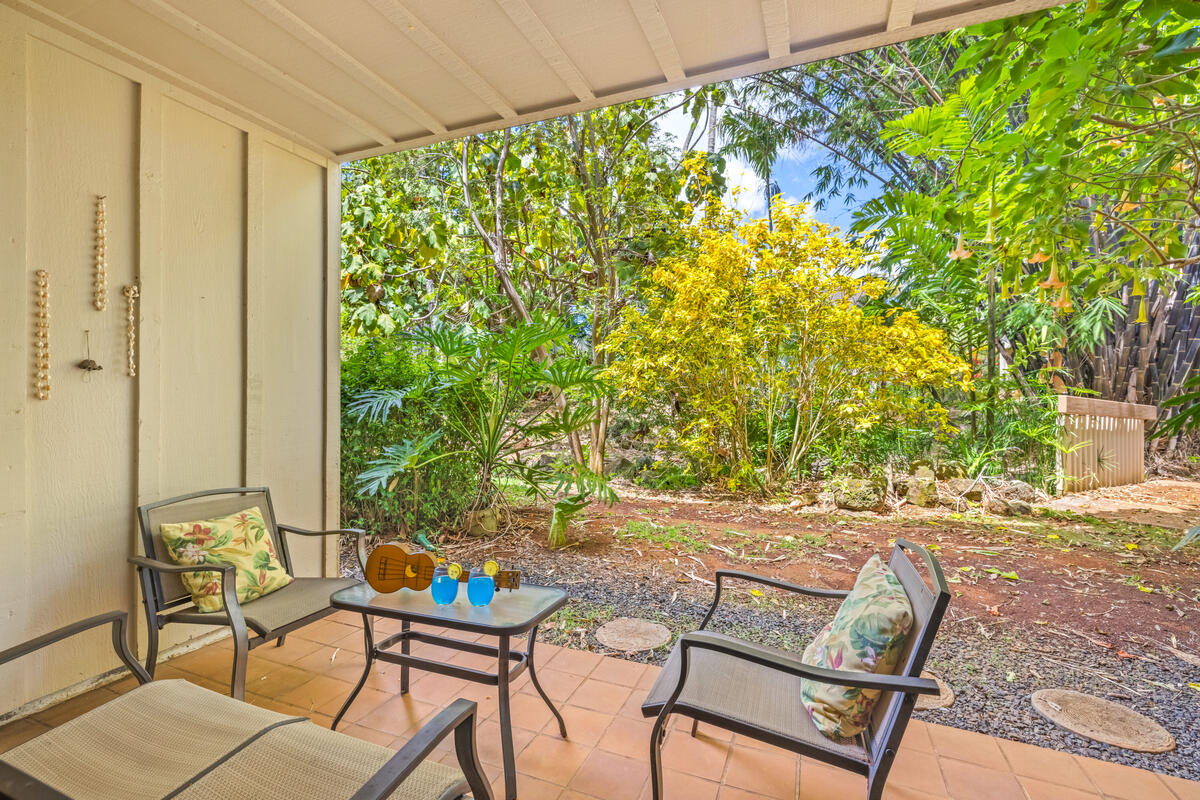 2721 Poipu Road, Unit 100 Koloa, HI 96756 - Photo 15 of 26 a backyard of a house with table and chairs