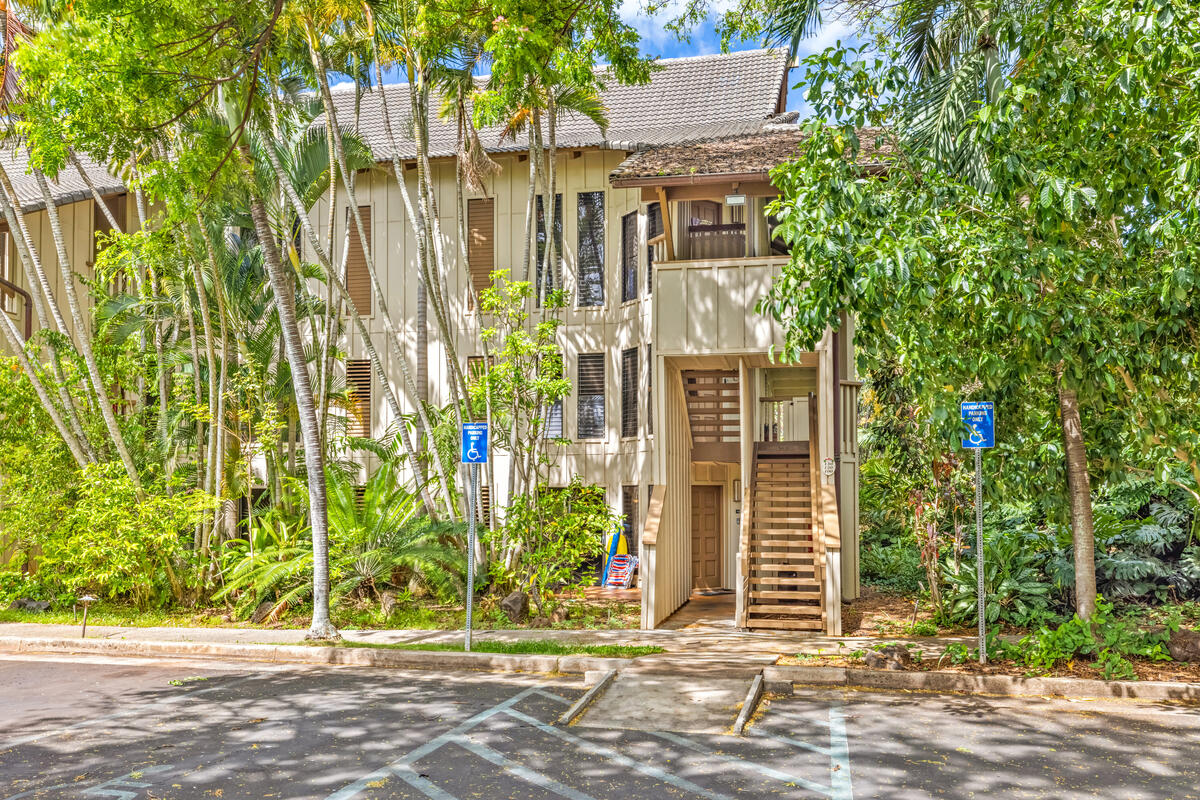 2721 Poipu Road, Unit 100 Koloa, HI 96756 - Photo 20 of 26 a front view of a house with a yard