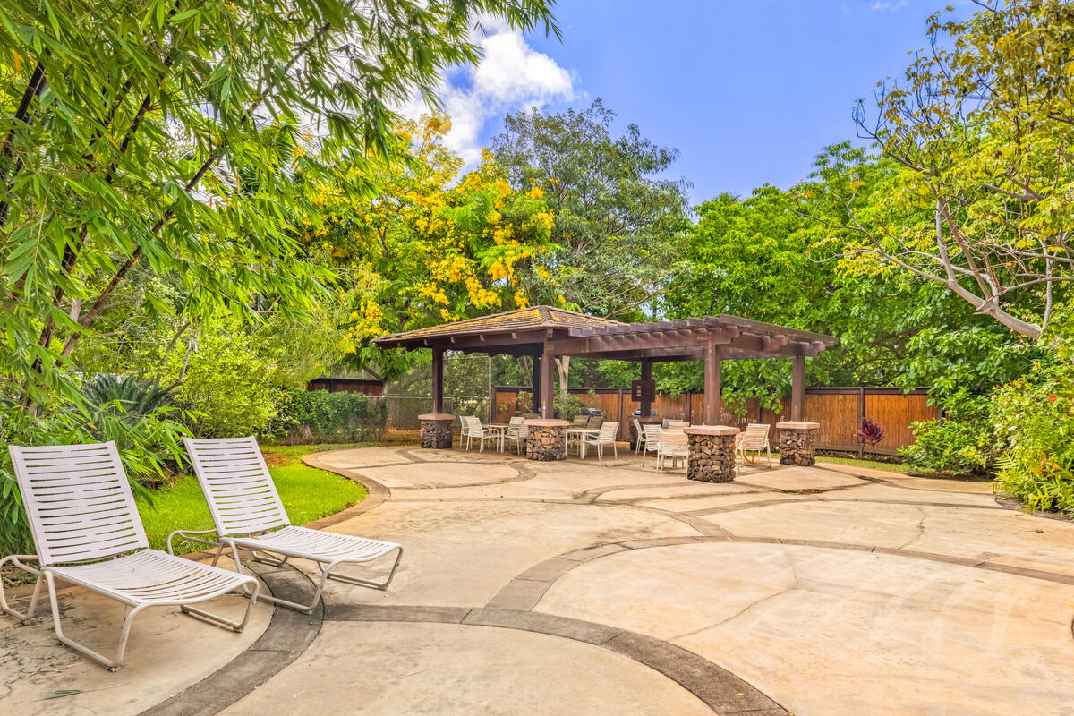 2721 Poipu Road, Unit 100 Koloa, HI 96756 - Photo 23 of 26 a view of pool with lawn chairs under an umbrella