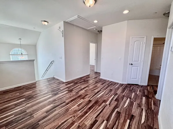a view of a room with wooden floor