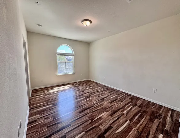 a view of a room with wooden floor