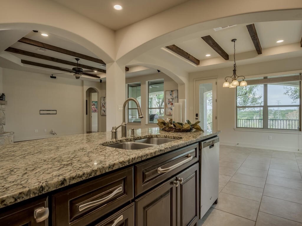 12912 Schleicher Trail Austin, TX 78732 - Photo 16 of 39 a kitchen with a sink and cabinets