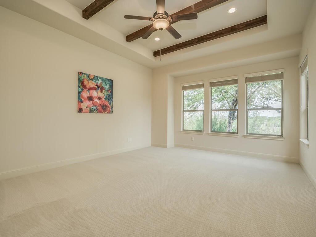 12912 Schleicher Trail Austin, TX 78732 - Photo 18 of 39 an empty room with windows and fan