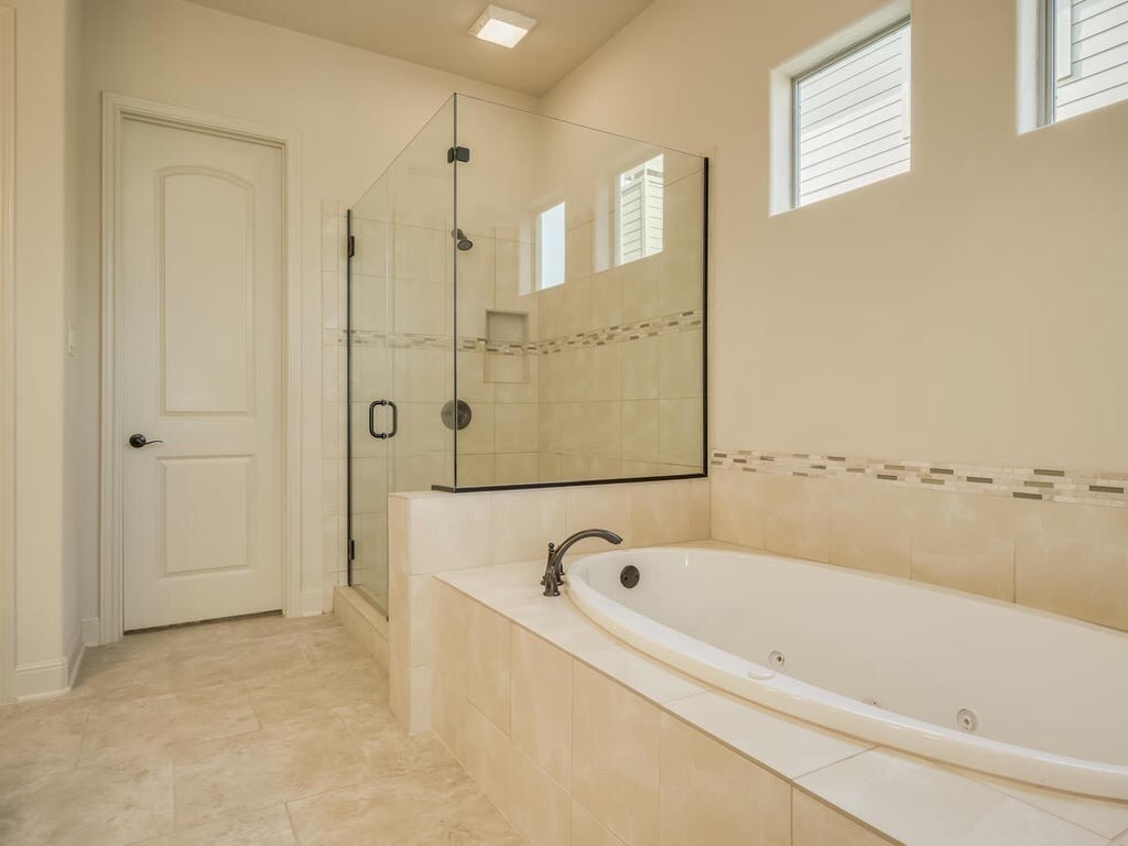 12912 Schleicher Trail Austin, TX 78732 - Photo 20 of 39 a bathroom with a bathtub and shower