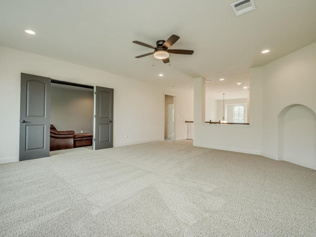 12912 Schleicher Trail Austin, TX 78732 - Photo 26 of 39 an empty room with windows and ceiling fan
