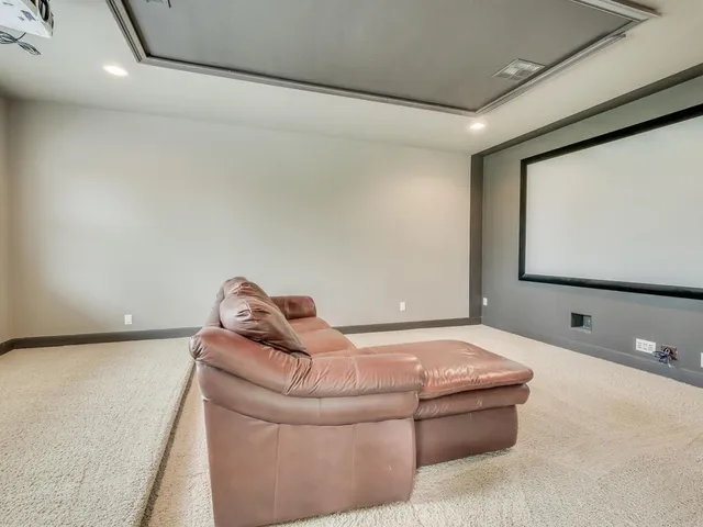 an empty room with windows and ceiling fan