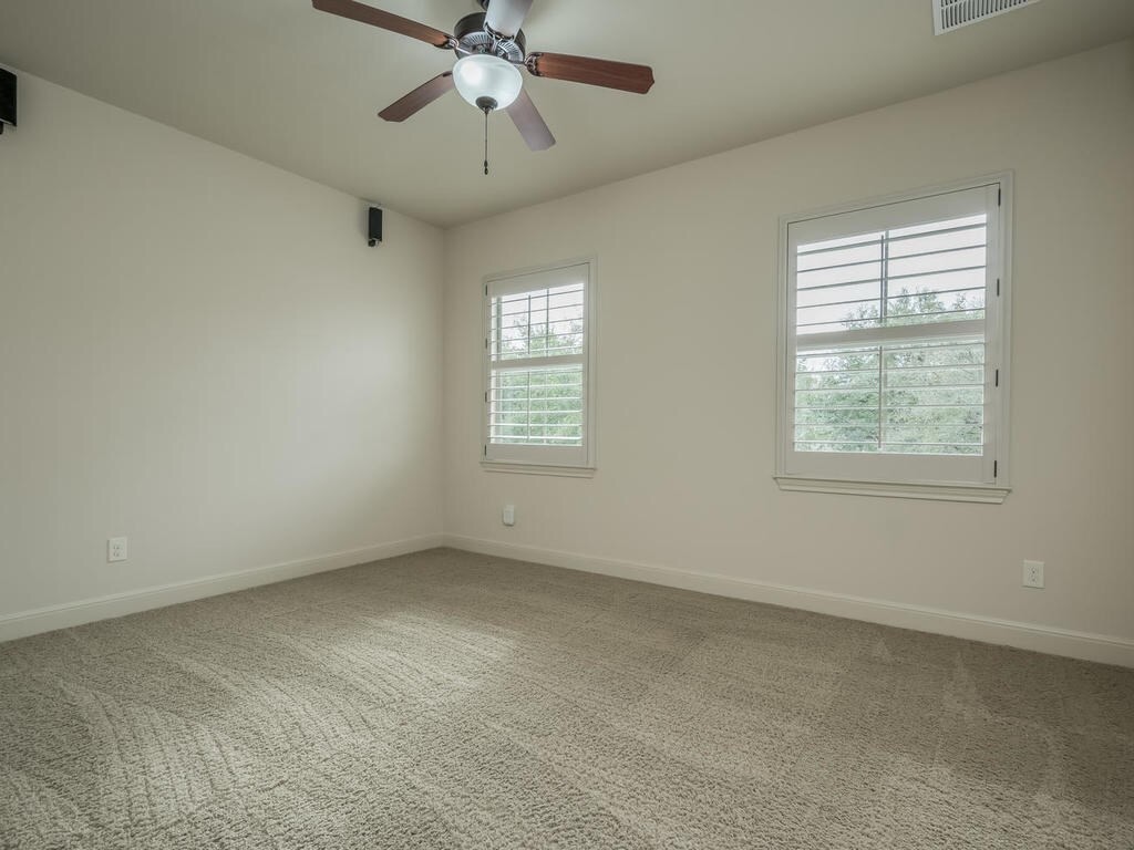 12912 Schleicher Trail Austin, TX 78732 - Photo 29 of 39 an empty room with a window and a fan