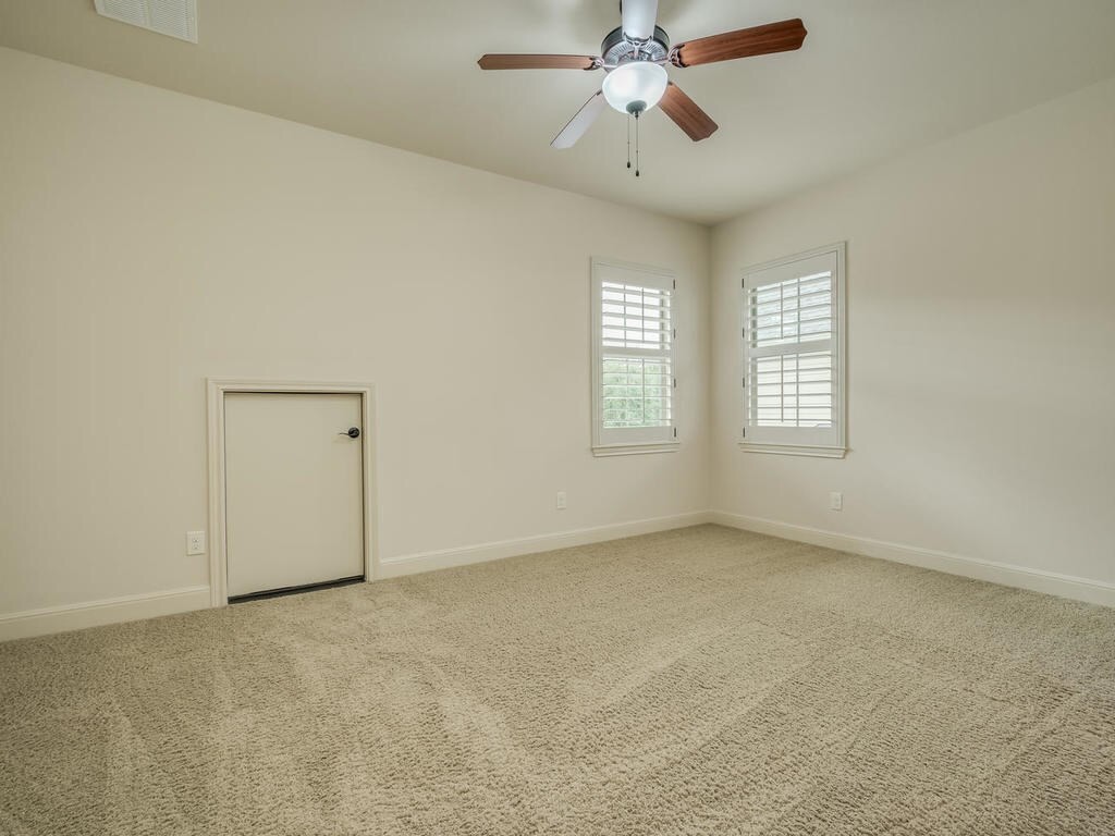 12912 Schleicher Trail Austin, TX 78732 - Photo 30 of 39 an empty room with windows and fan