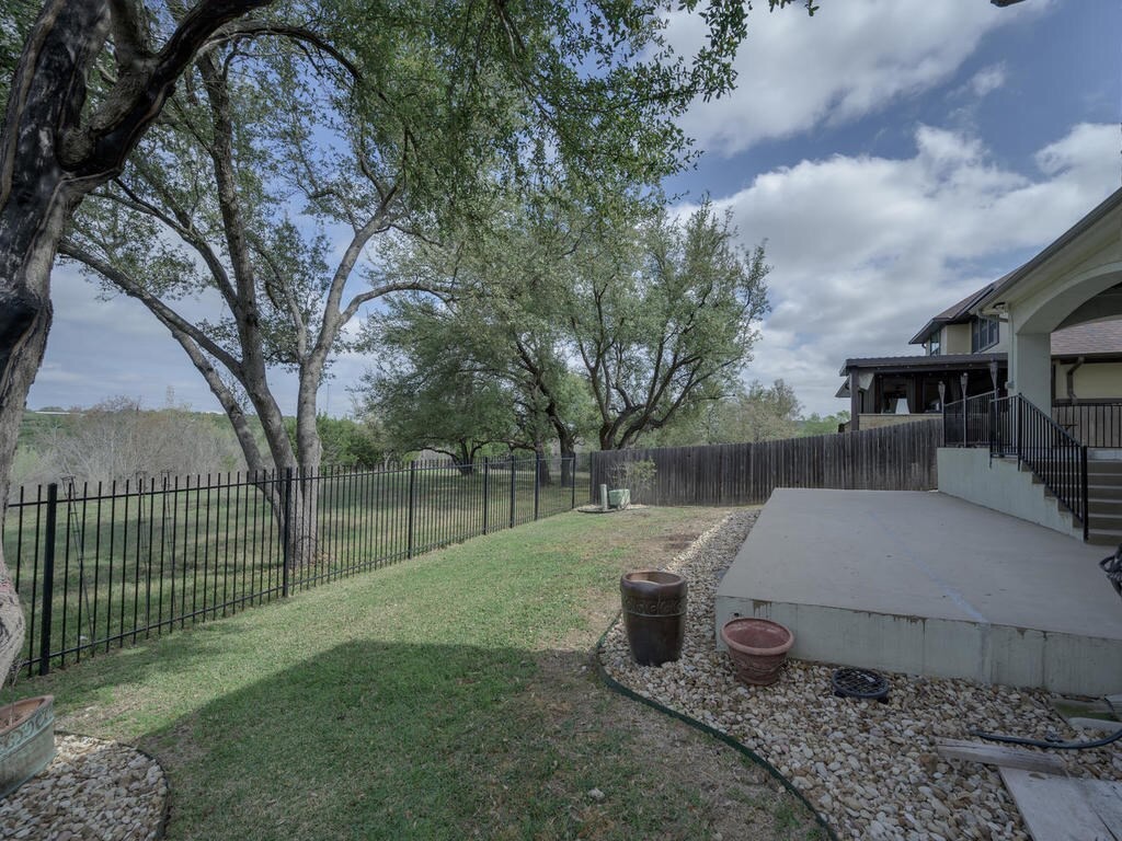 12912 Schleicher Trail Austin, TX 78732 - Photo 36 of 39 a view of backyard with wooden fence