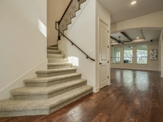 a view of entryway and hall with wooden floor