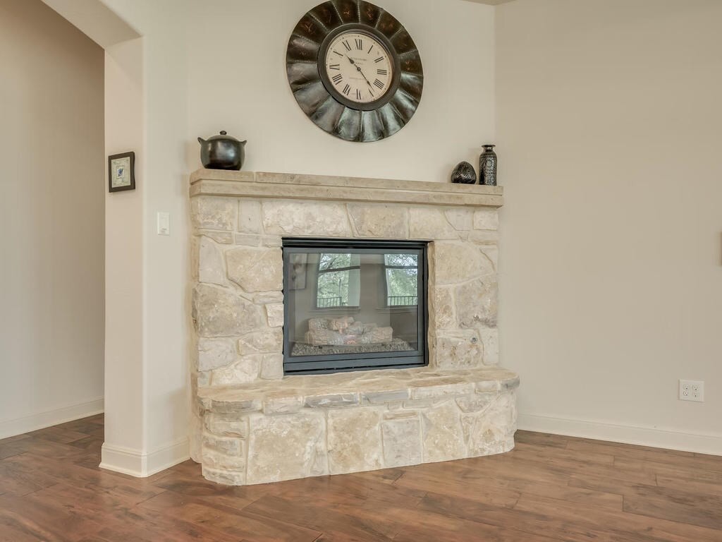 12912 Schleicher Trail Austin, TX 78732 - Photo 7 of 39 a stone house with a fireplace in it