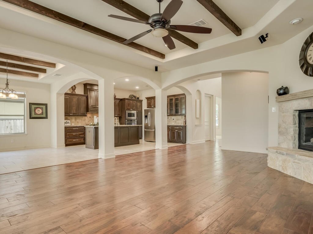 12912 Schleicher Trail Austin, TX 78732 - Photo 8 of 39 a view of a hall with wooden floor and a ceiling fan