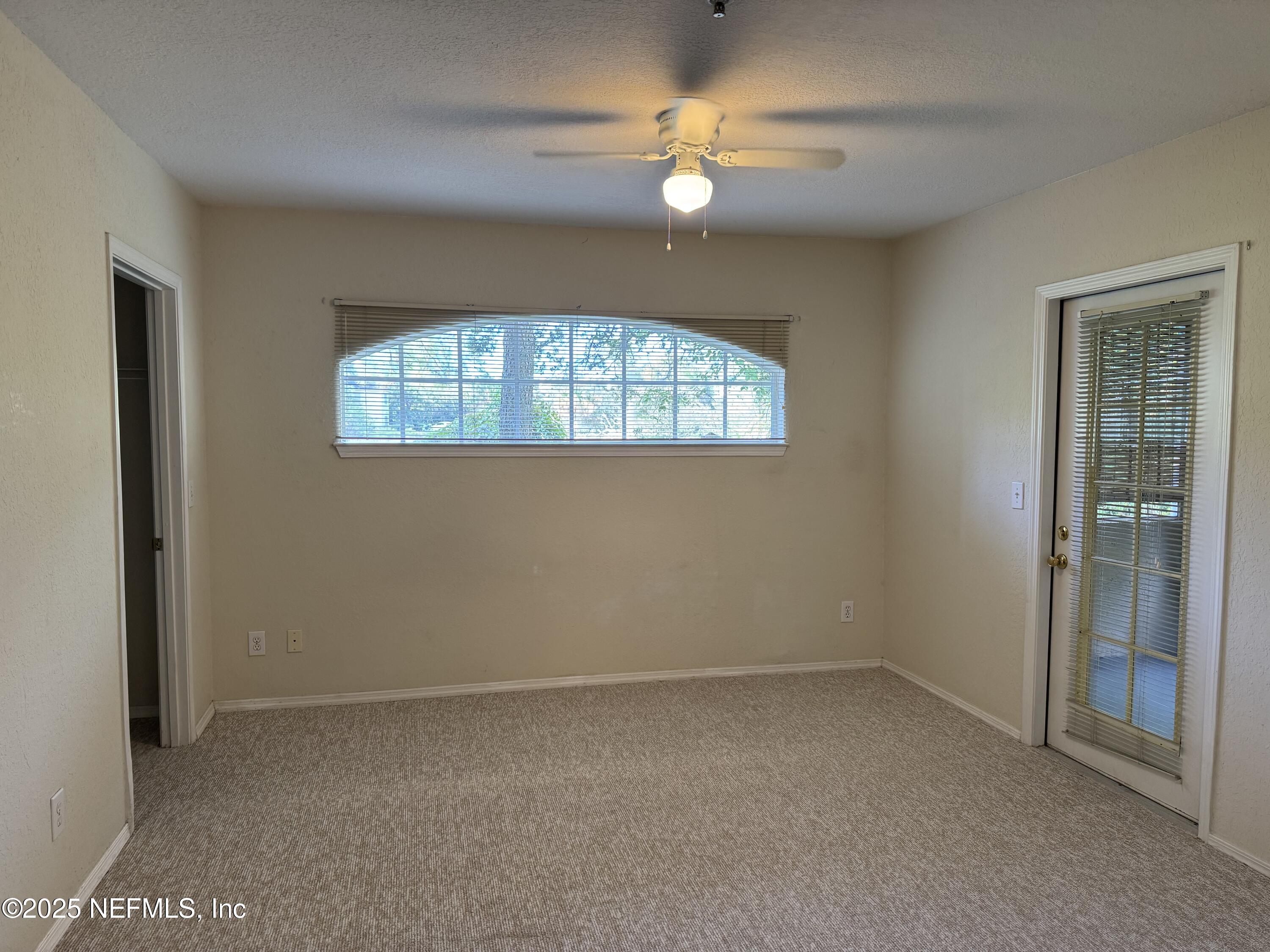 1701 The Greens Way, Unit 214 Jacksonville Beach, FL 32250 - Photo 10 of 21 an empty room with a window