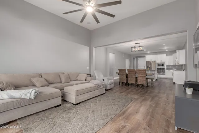 a living room with furniture and a chandelier