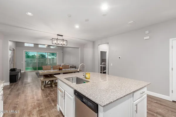 a kitchen with stainless steel appliances granite countertop a sink and stove