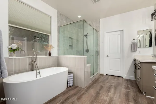 a white bath tub sitting in a en suite bathroom