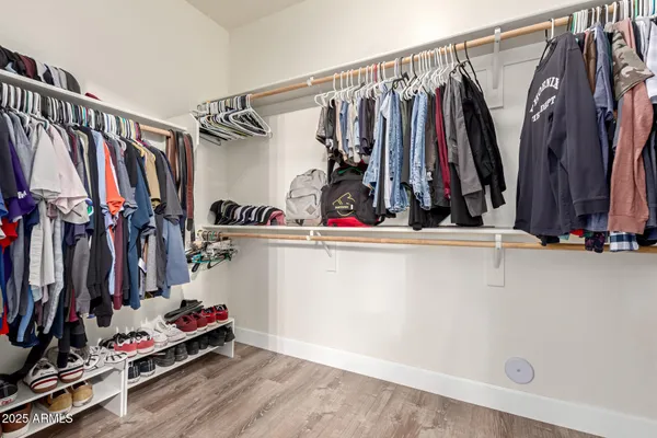 a view of walk in closet with clothes