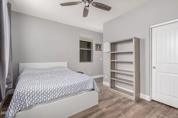 a bedroom with a bed and a ceiling fan