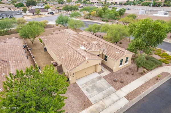 an aerial view of a house with a yard and lake view in back