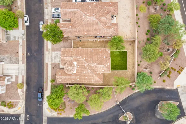 an aerial view of a residential houses with outdoor space