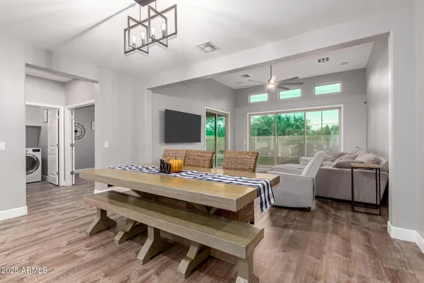 a living room with furniture flat screen tv and a large window