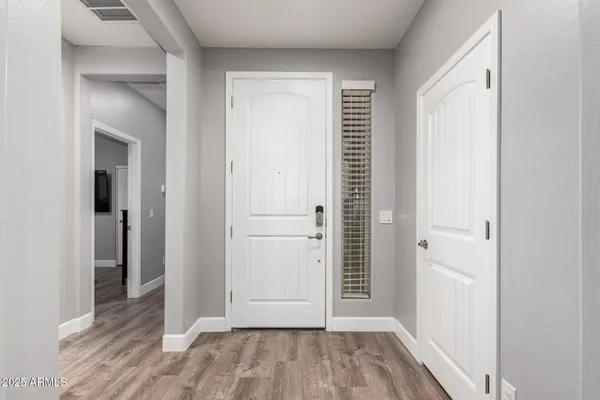 a view of a hallway with wooden floor
