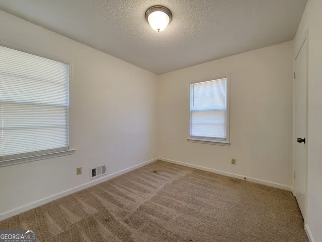 an empty room with a empty space and window